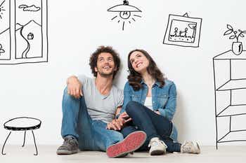 Couple sitting on the floor thinking about buying a house