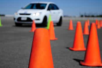 Car on driving course with many cones