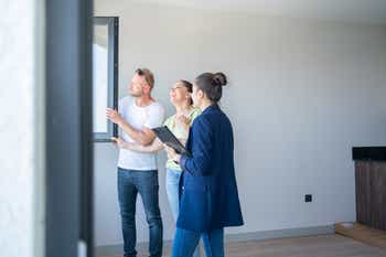 Real estate agent showing property to family