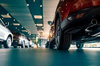 Rearview car parked in luxury showroom. Car dealership office. New car parked in modern showroom