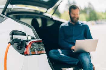 Man charging electric car