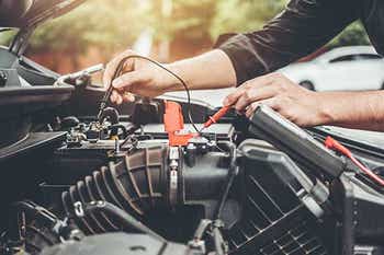 Mechanic working on a car battery