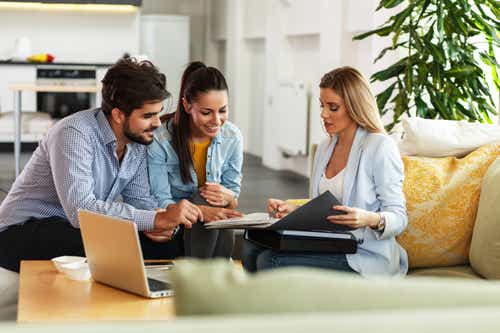 Female Real Estate agent offer home ownership and life insurance to young couple.