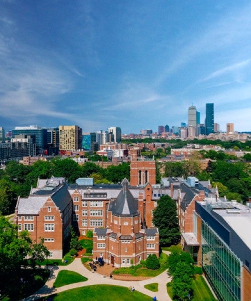 Aerial shot of Emmanuel College campus with Boston skyline in background