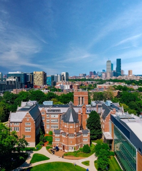 Aerial shot of Emmanuel College campus with Boston skyline in background