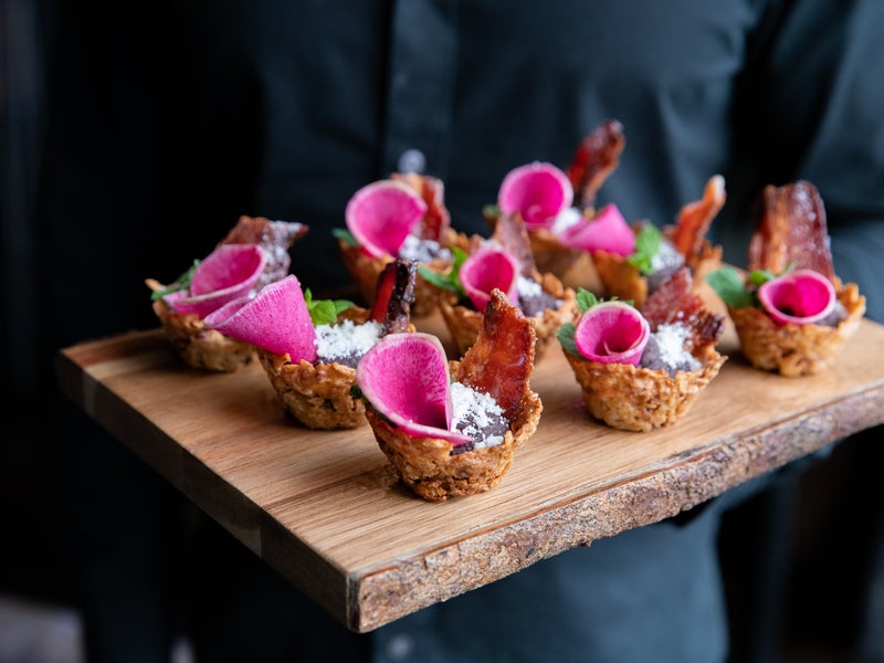 Appetizers displayed on a wooden cutting board