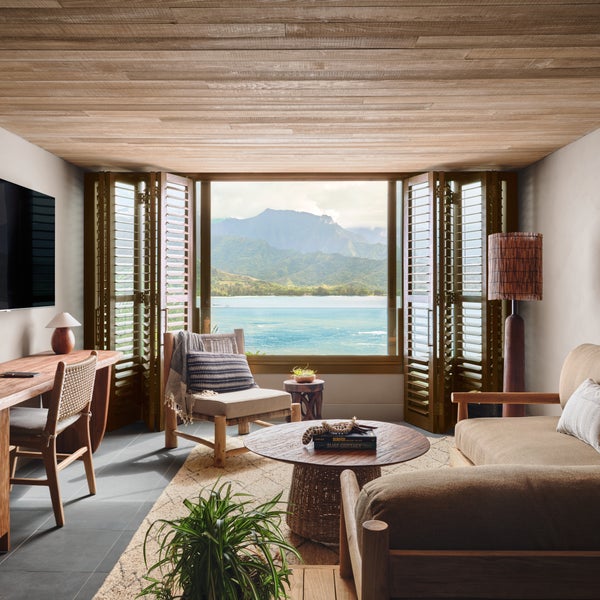 Living area with a deep sectional couch and a window looking out to the water