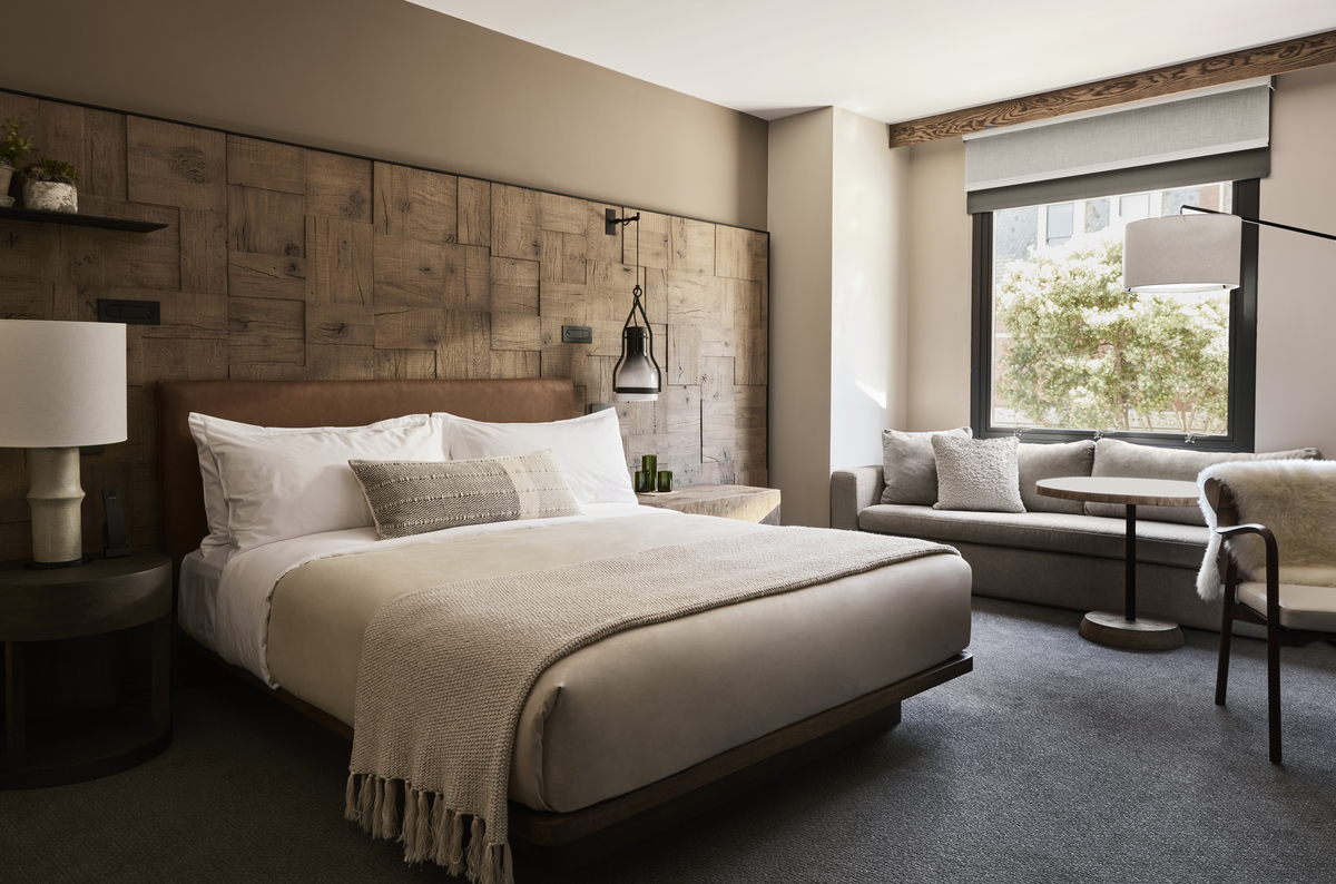Dark colored hotel room with a large bed