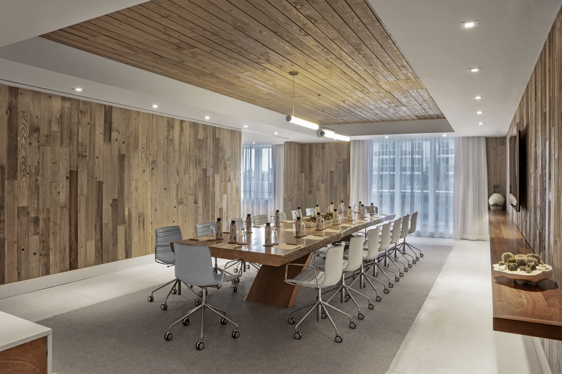 A conference room with a desk and chairs