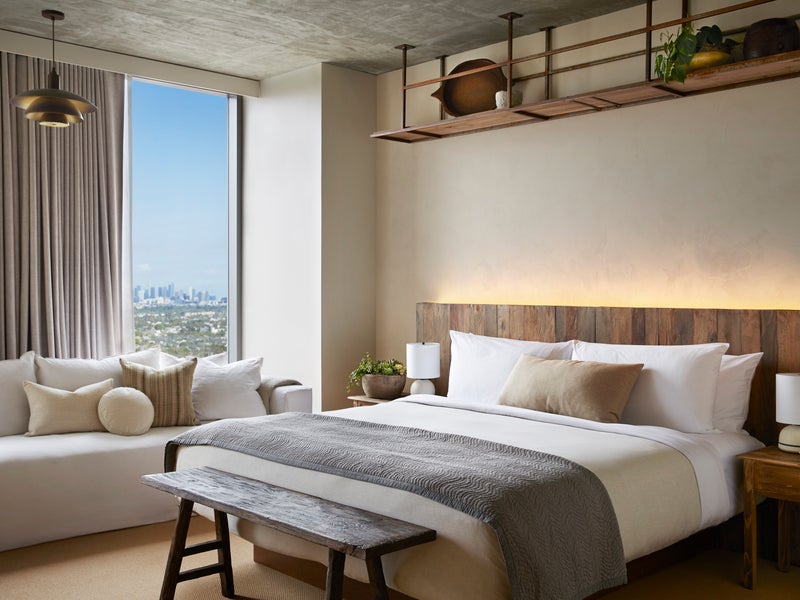 A king size bed with a white sofa adjacent