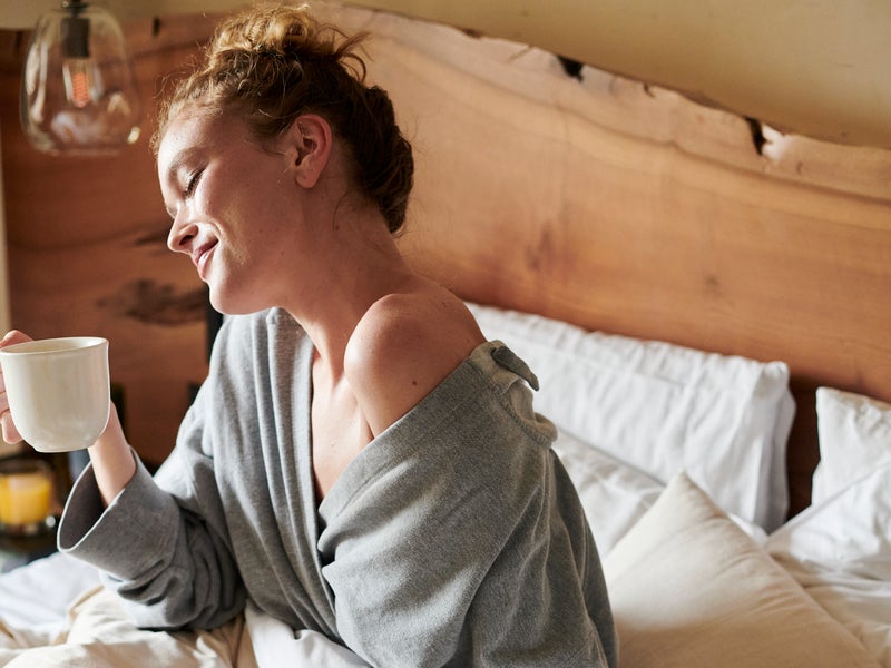 Woman eating breakfast in bed