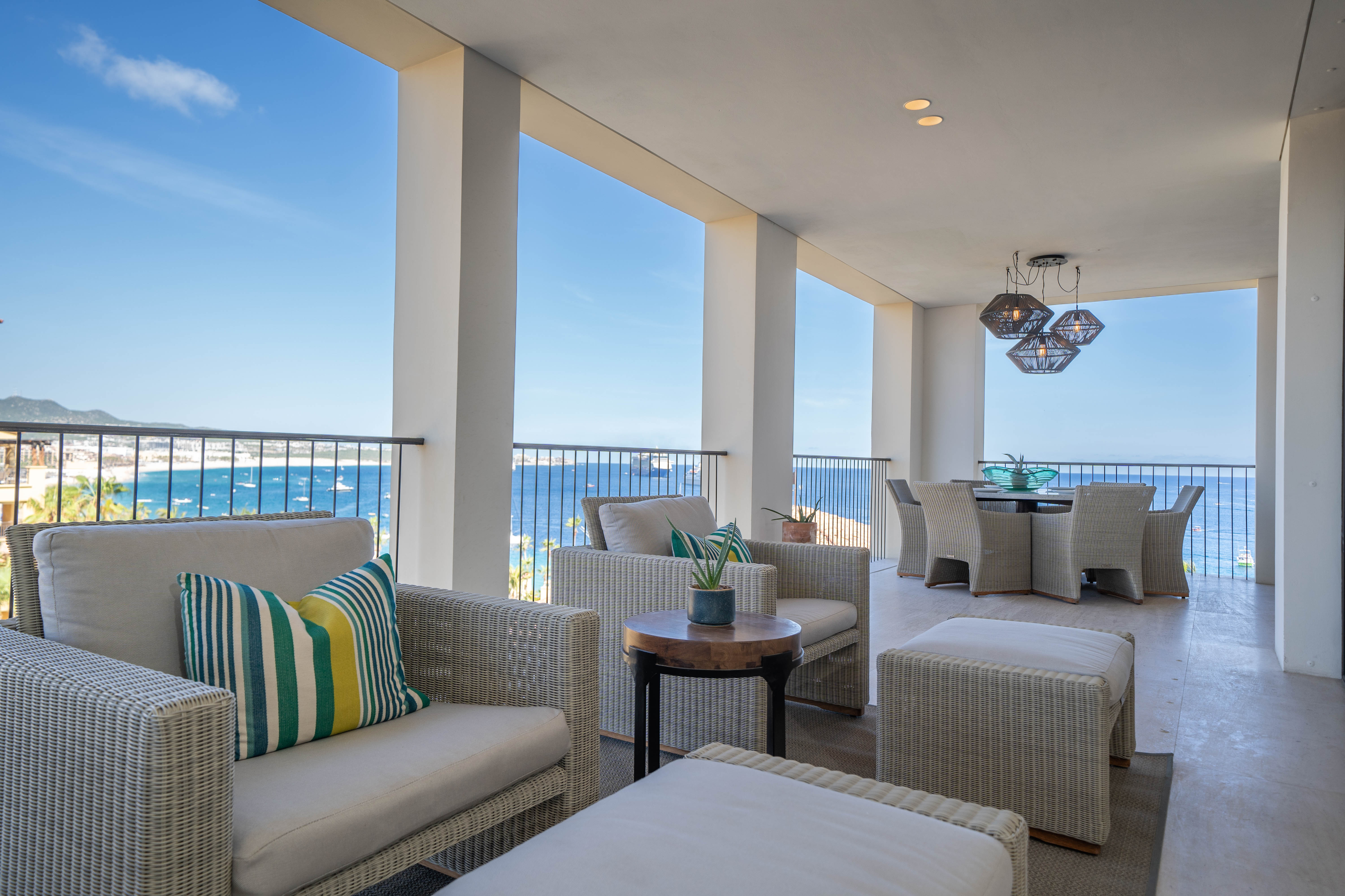 Balcony with several lounge chairs overlooking the ocean