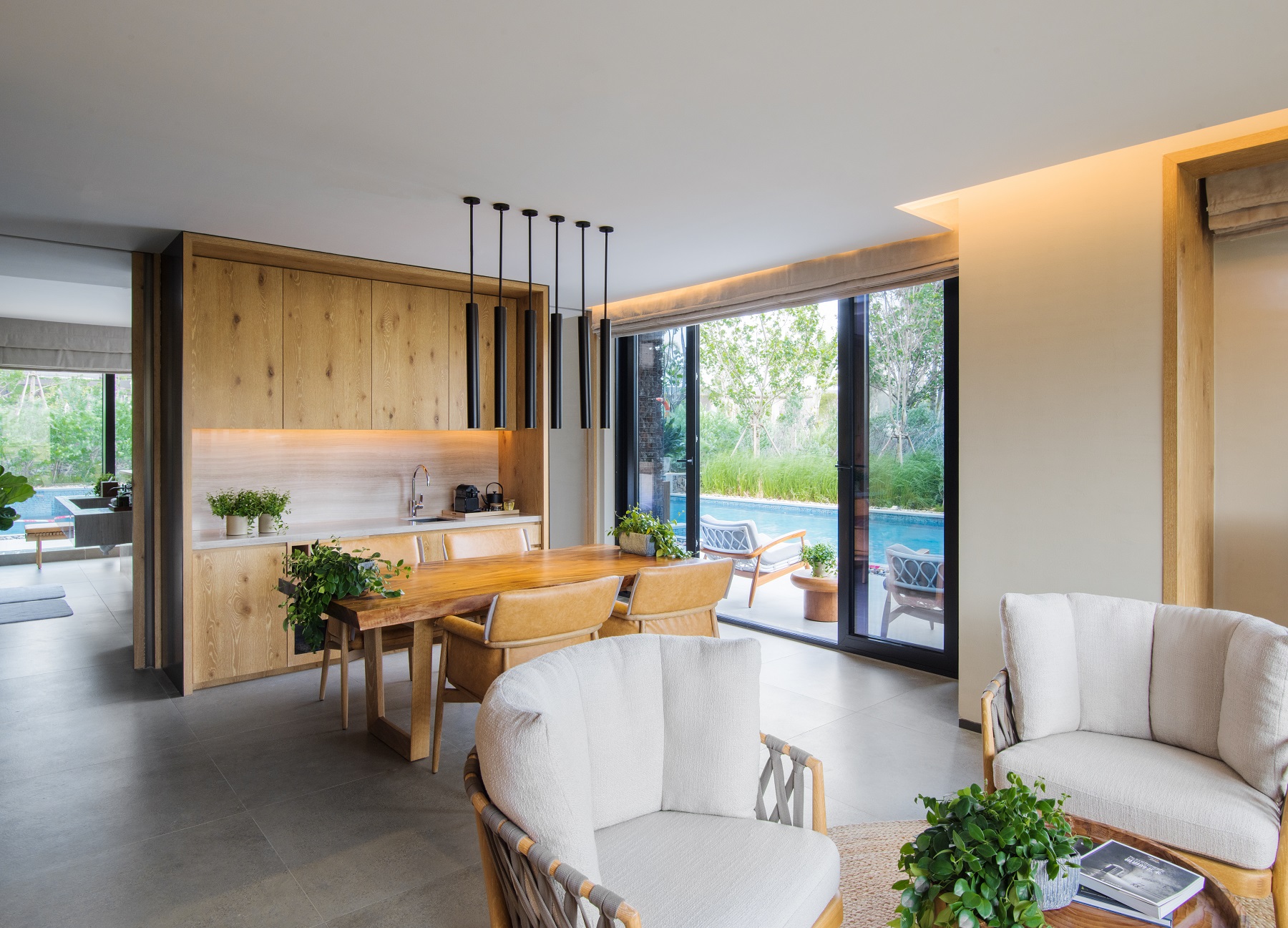 Indoor living room area with a pool outside