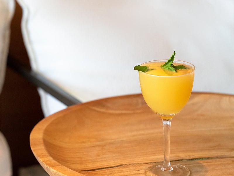 Orange cocktail on a bedside table