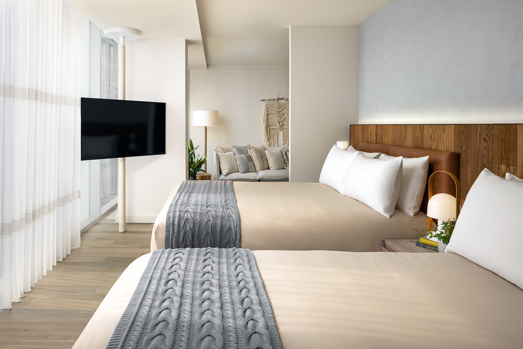 A room with two queen size beds and a television