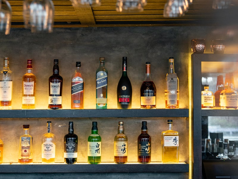 Bar shelves lined with various spirits