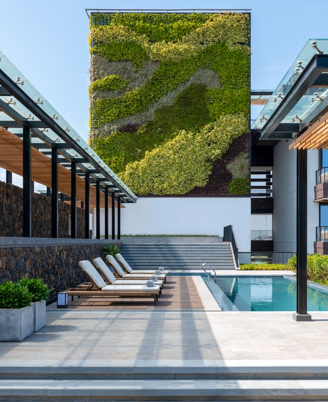 An eco-friendly green wall provides a refreshing backdrop to the Sky Villa pool area