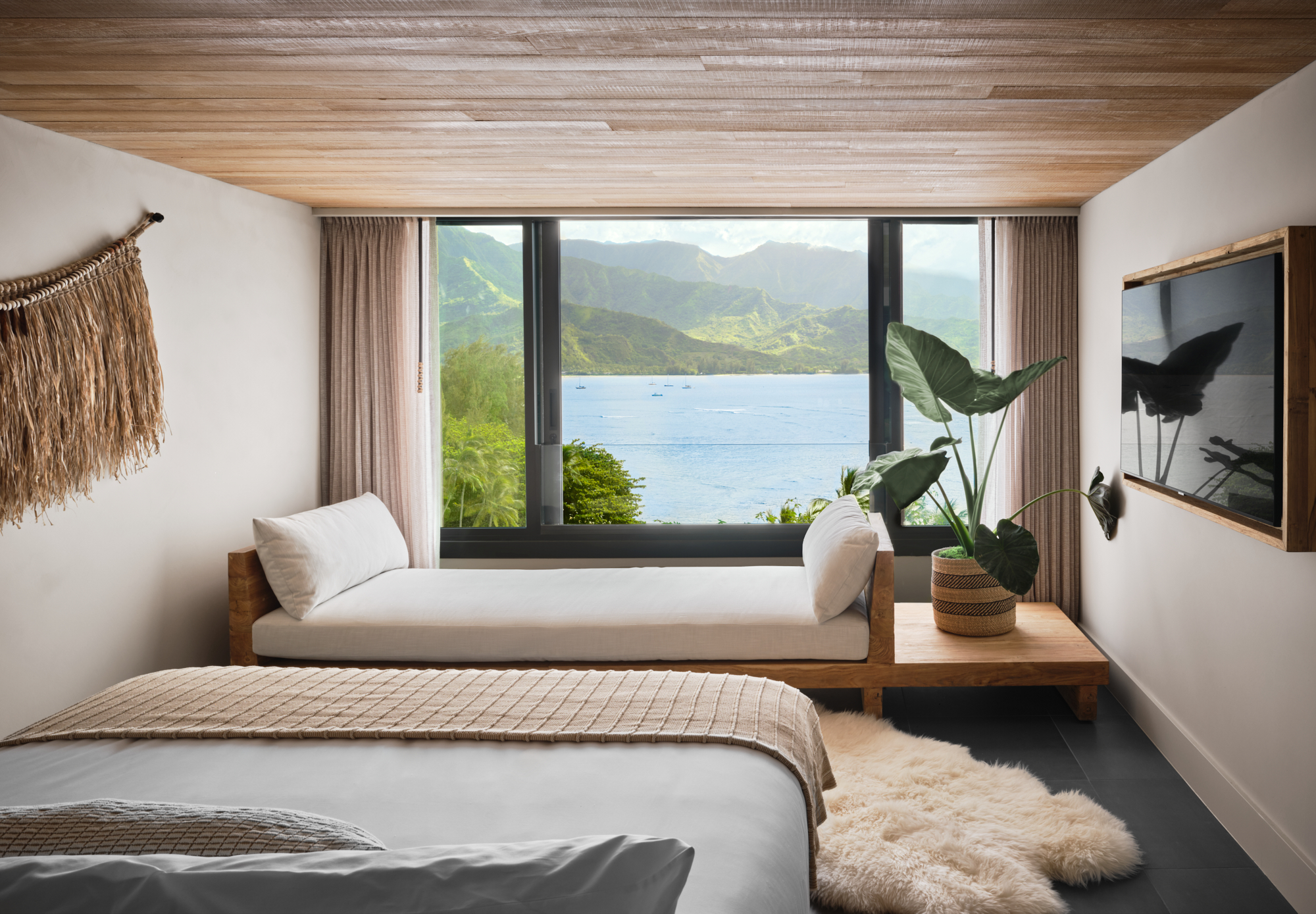 A hotel room with a view of the ocean just outside