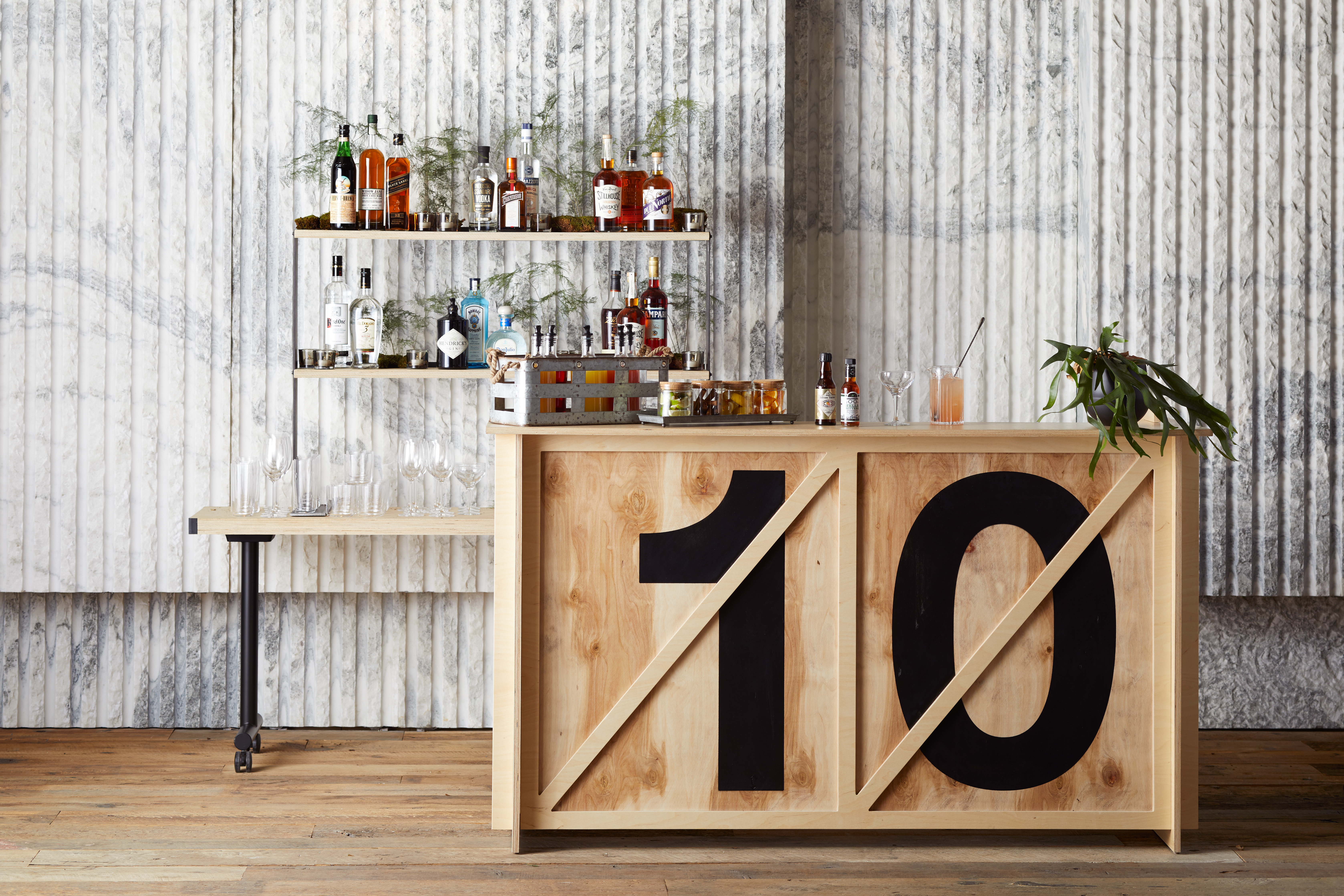 Meadow Rue satellite bar featuring a full rack of varying alcohol and spirits