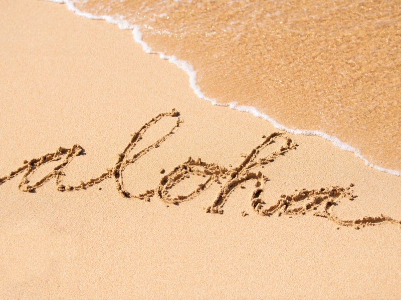 "Aloha" written in the sand