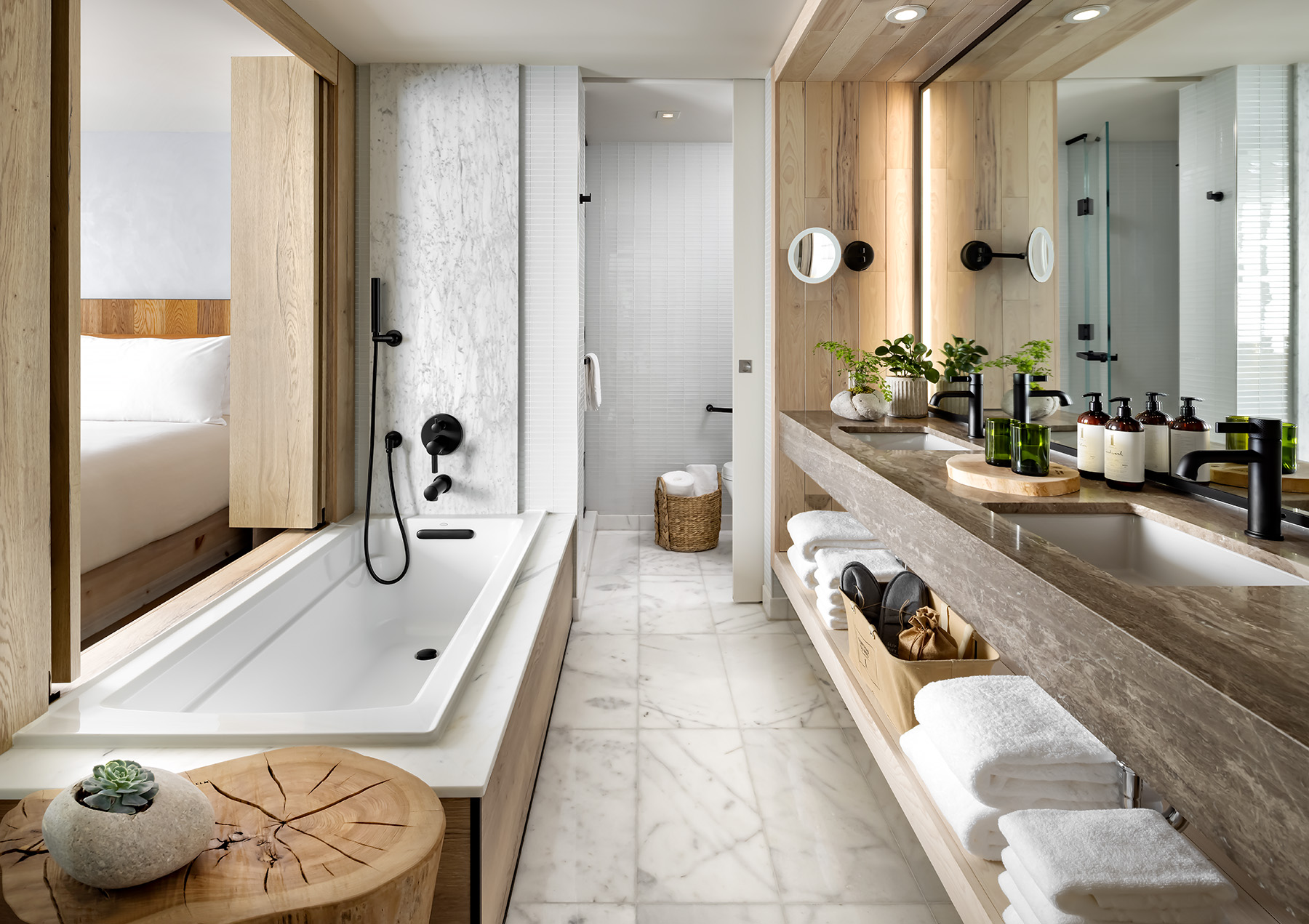 Long narrow bathroom with double sinks and a bathtub