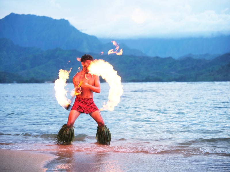 Person dancing with fire on the beach