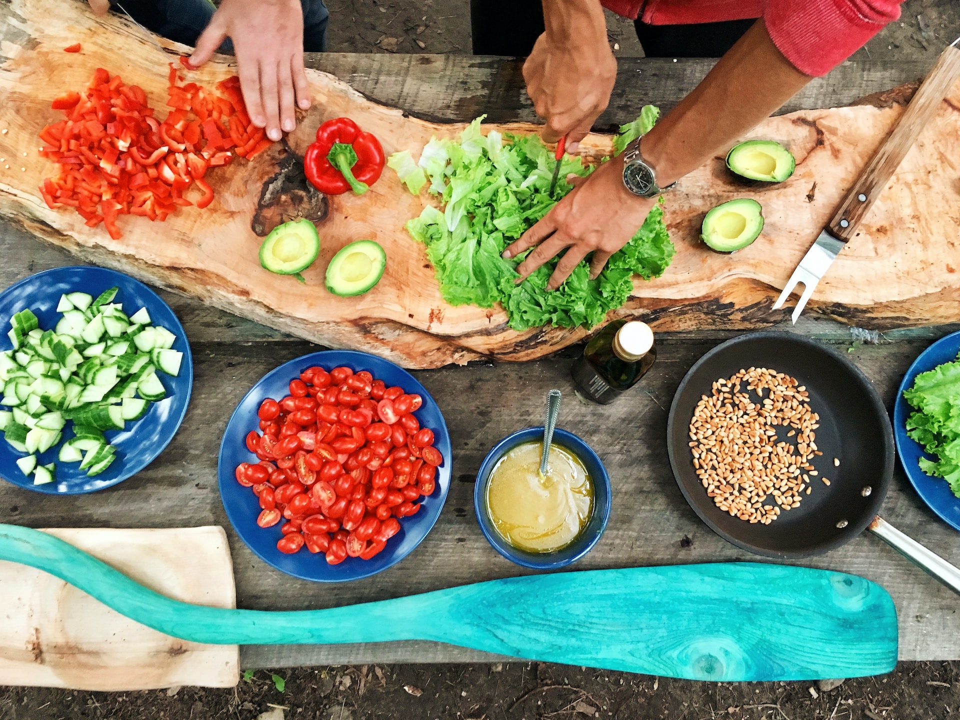 Food Ingredients spread to a rustic table with Sous Chef's chopping