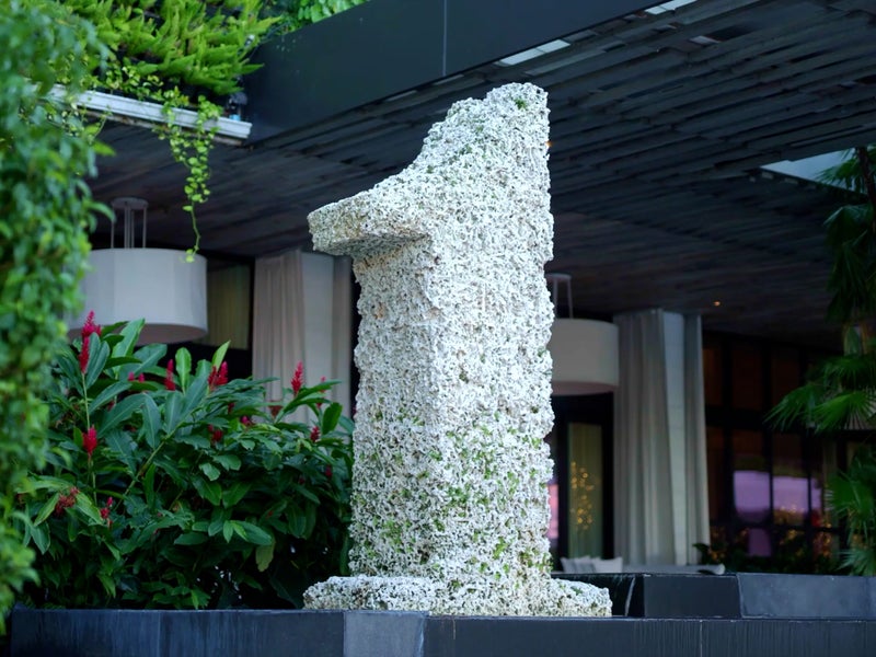 A sculpture of the 1 Hotels branded one logo