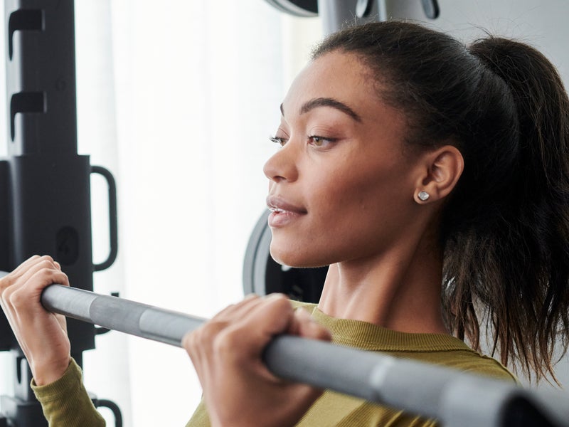 Woman is exercising in gym