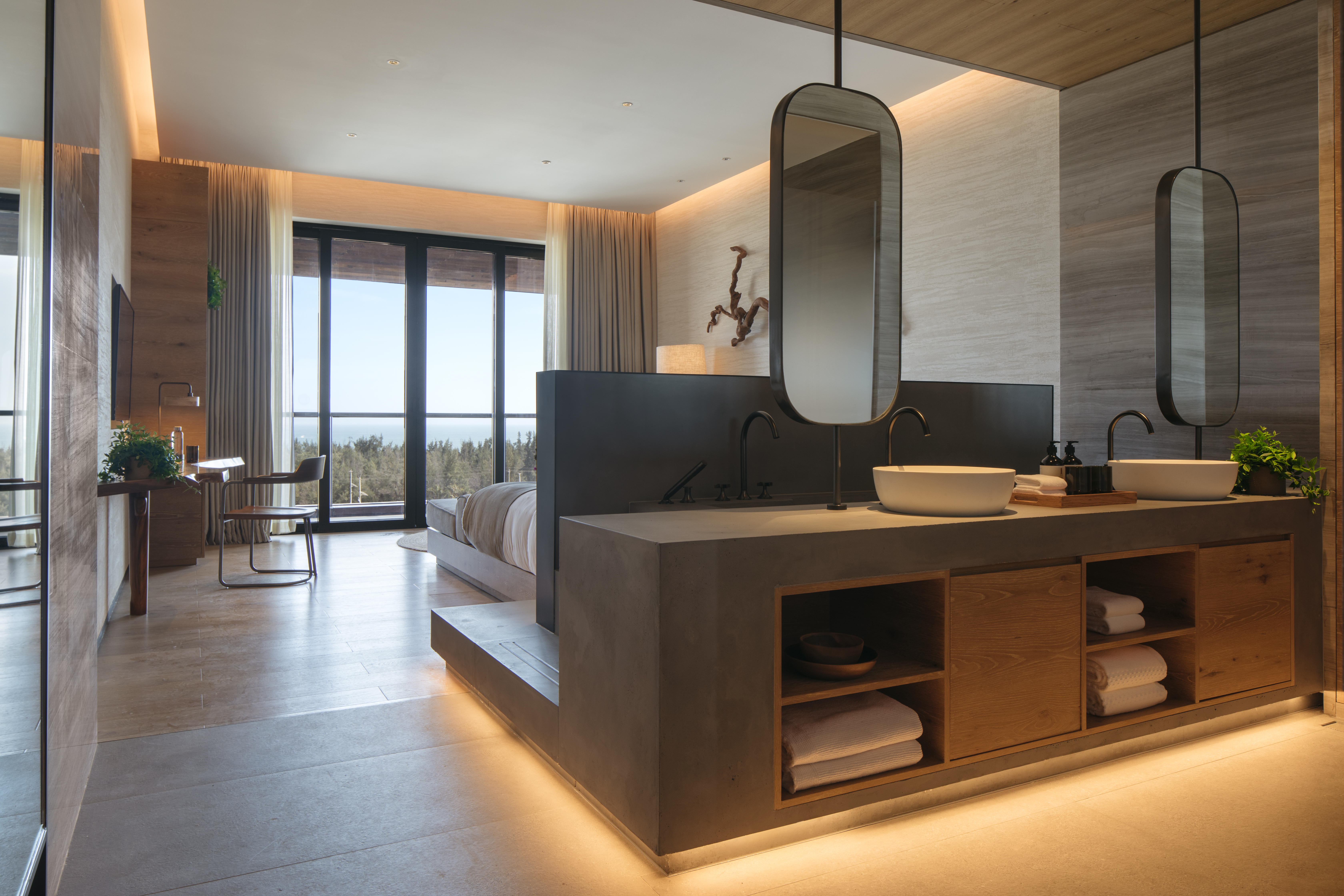 Hotel room with double sinks and a view out to the ocean