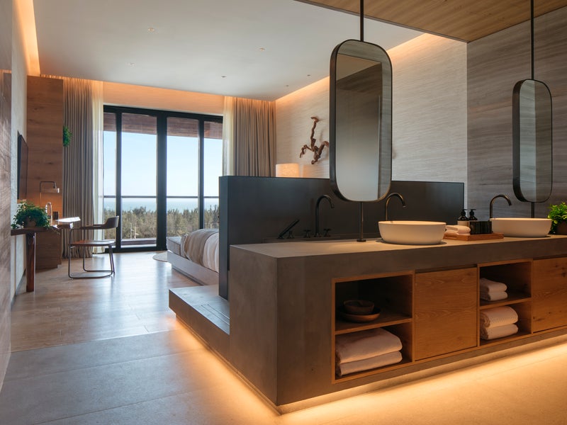 Hotel room with double sinks and a view out to the ocean