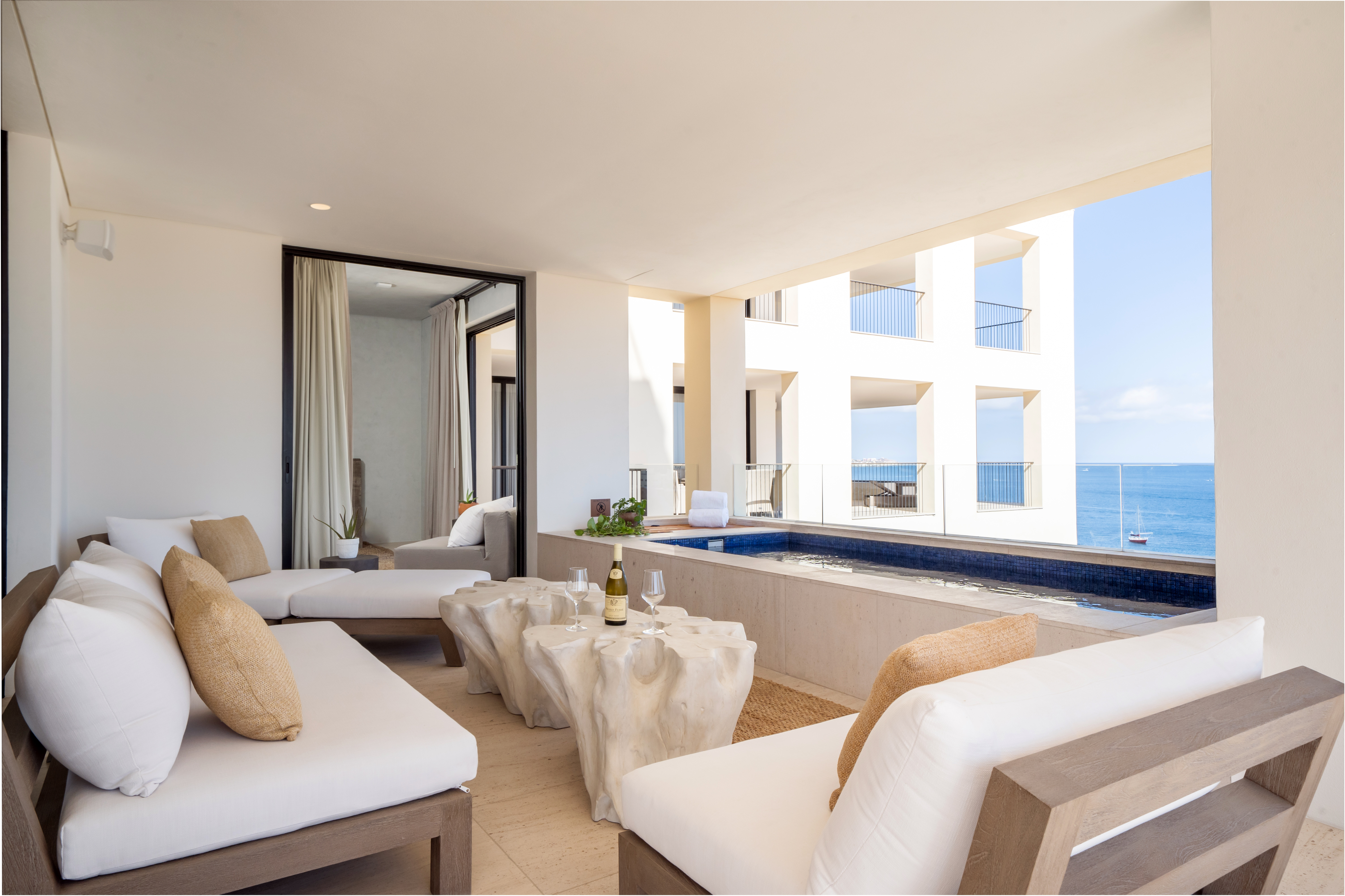 Chairs surrounding white teak wood root coffee tables