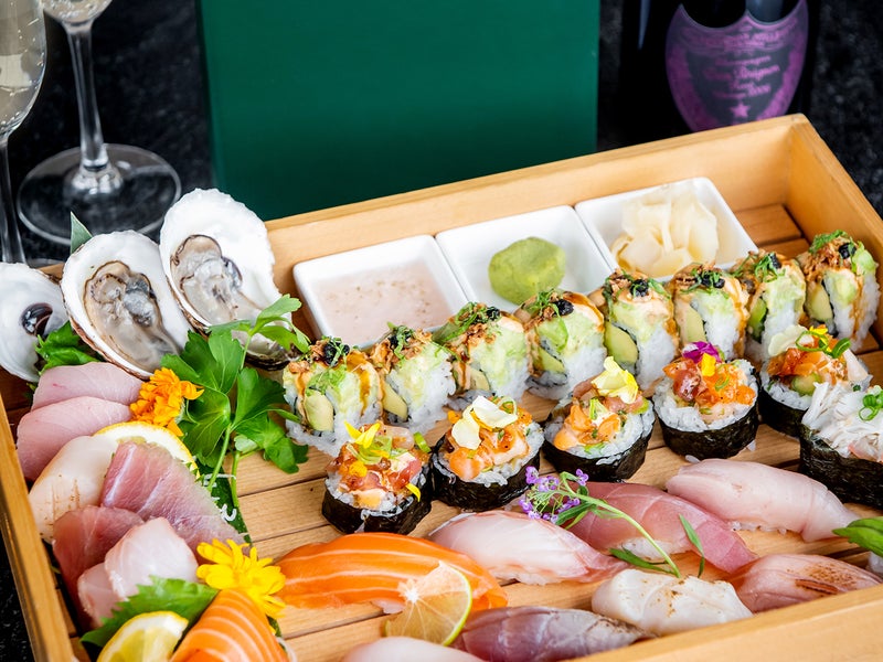 A bento box with sushi and oysters