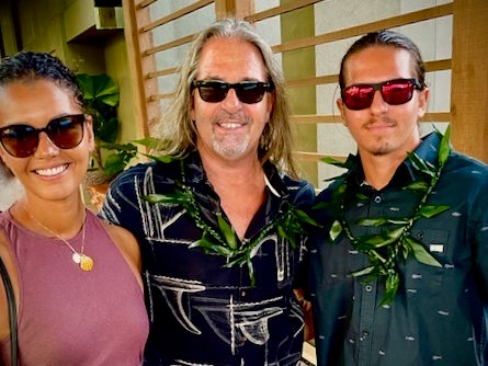 Three people with sunglasses, posing for a photo