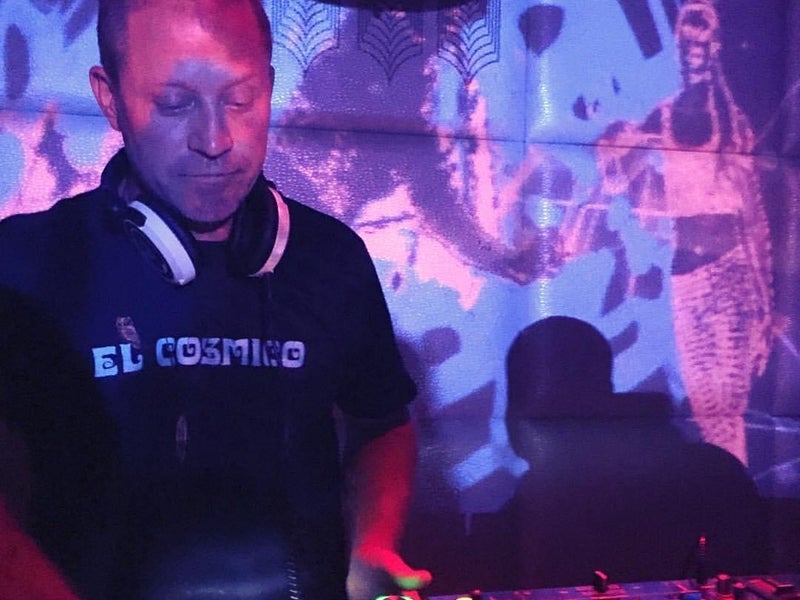 DJ performing a set with purple lights