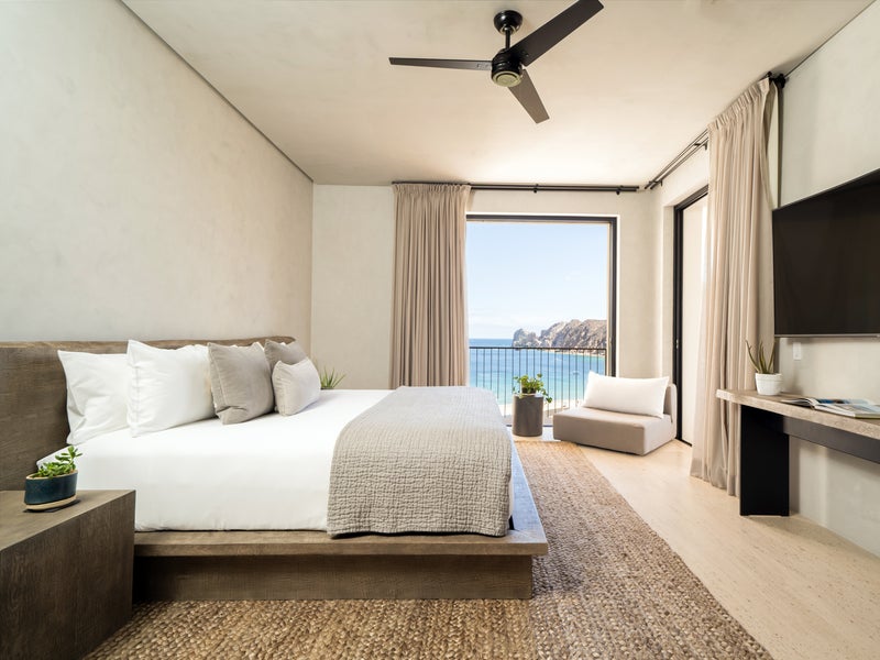 Made bed across from a tv