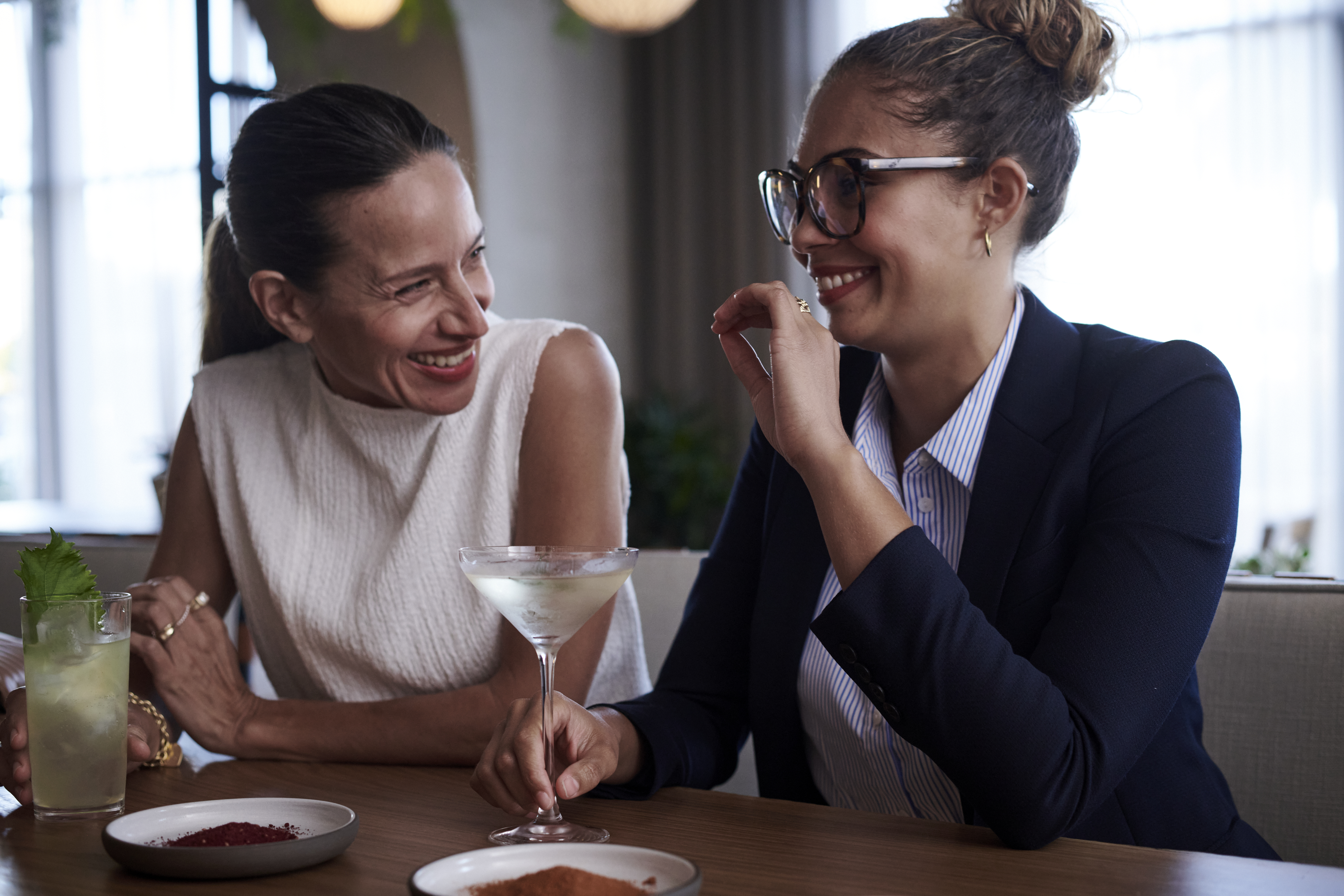 Two people chatting at a bar