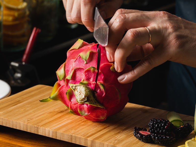 Person slicing a dragonfruit