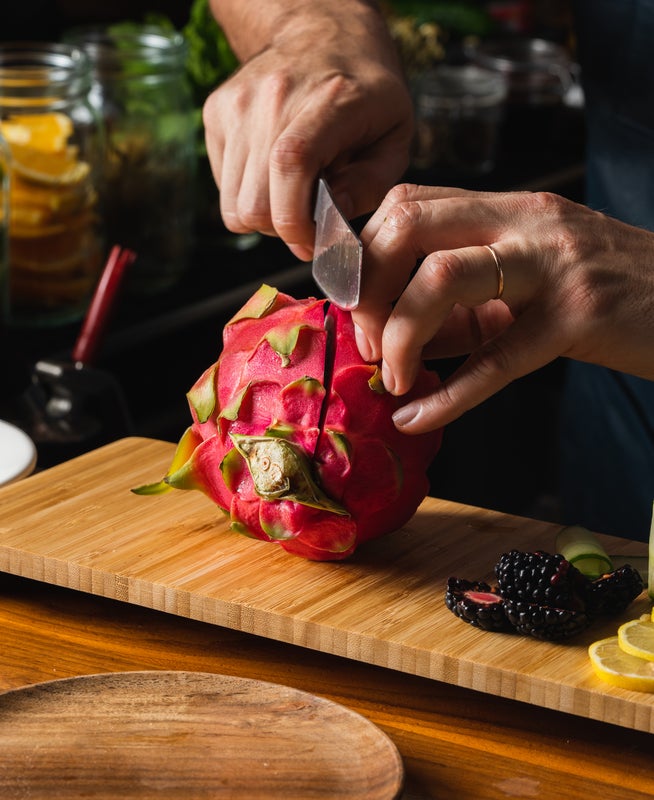Person slicing a dragonfruit