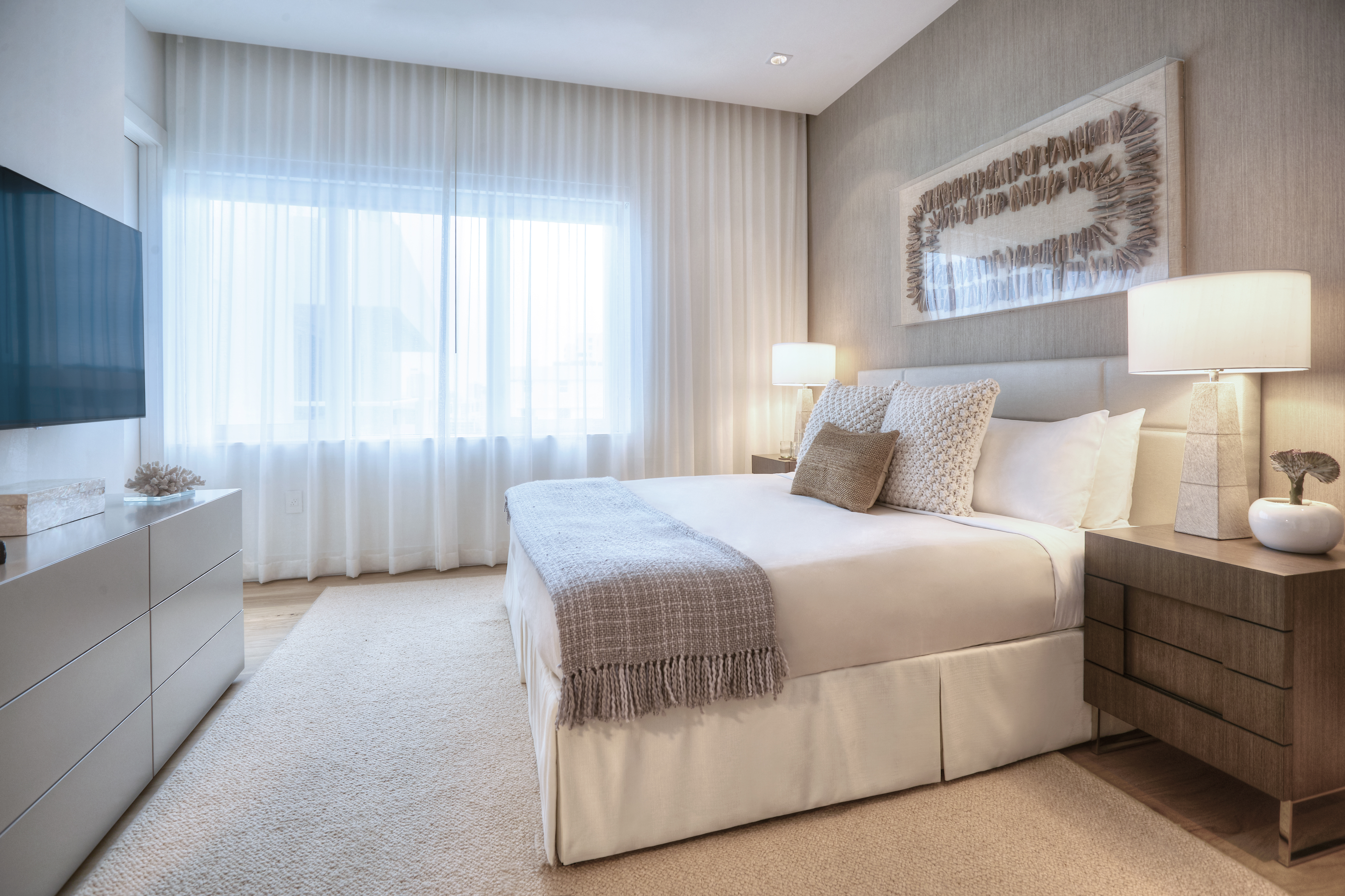 A bed with 2 side tables and a tv