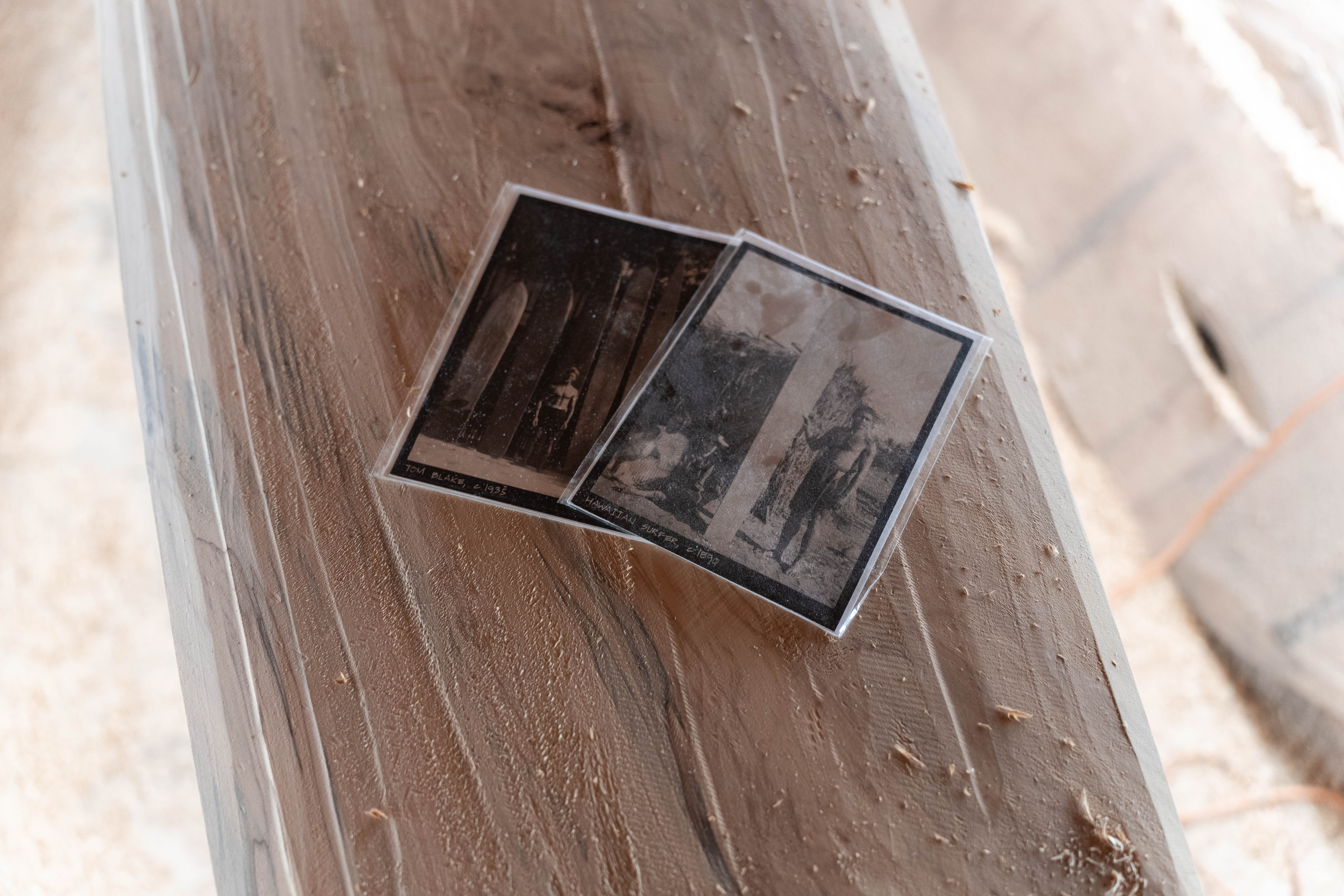 Two black and white photos of surfers