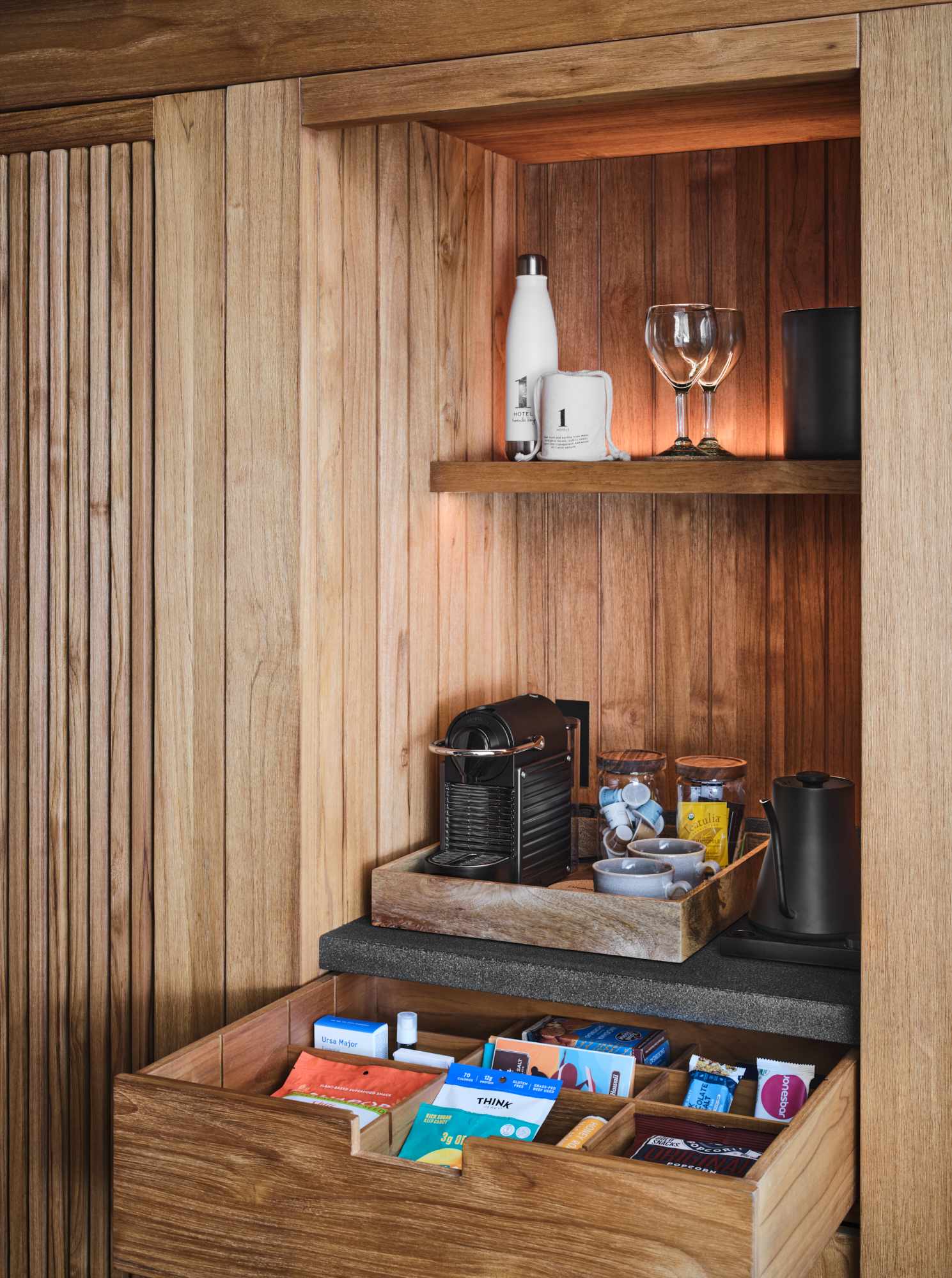 In room bar with nespresso machine and drawer full of snacks