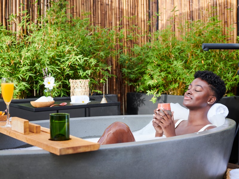 Person relaxing in an outdoor bathtub