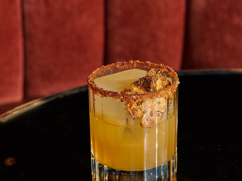 A cocktail with gold flakes