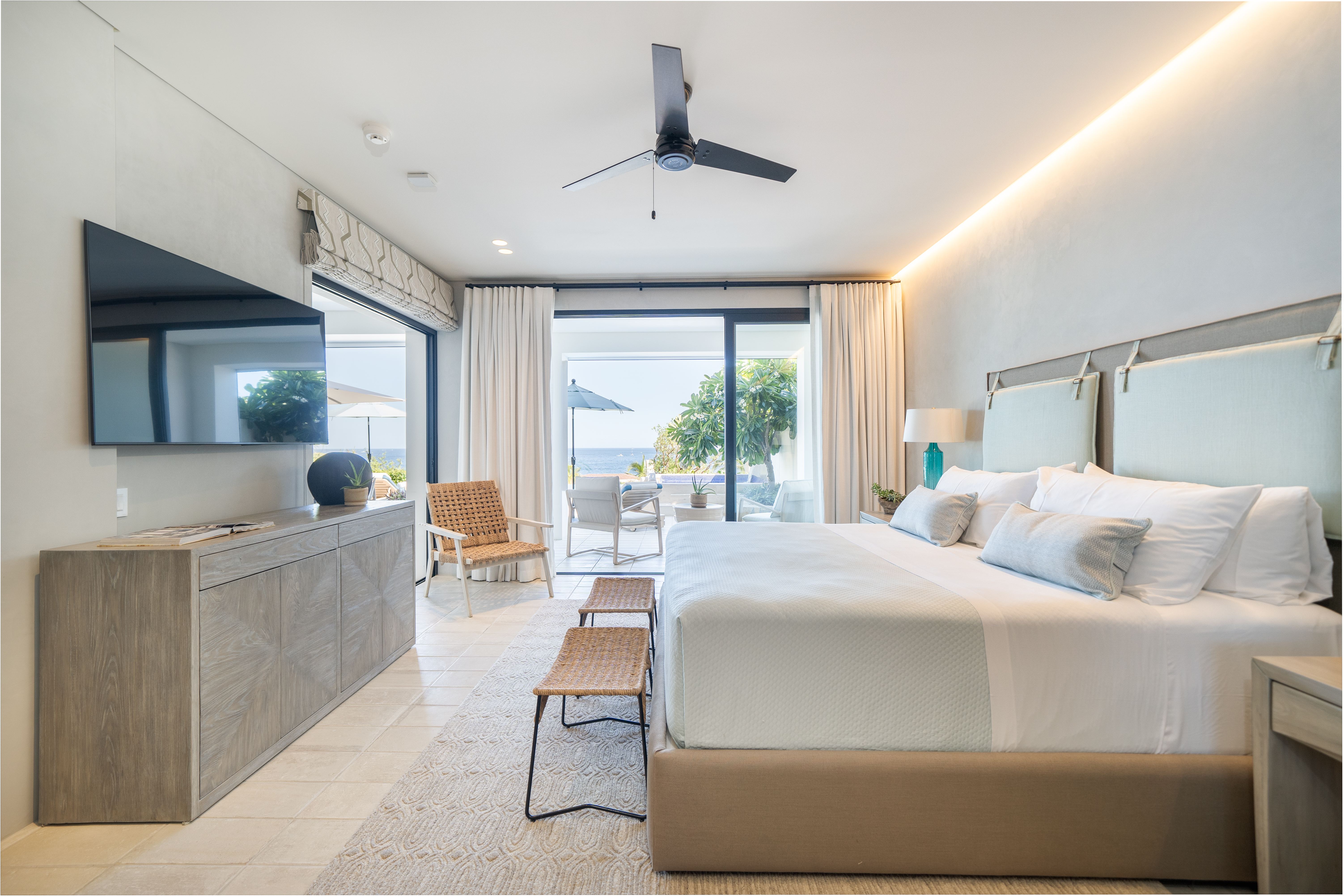 Bedroom with wicker chairs and benches