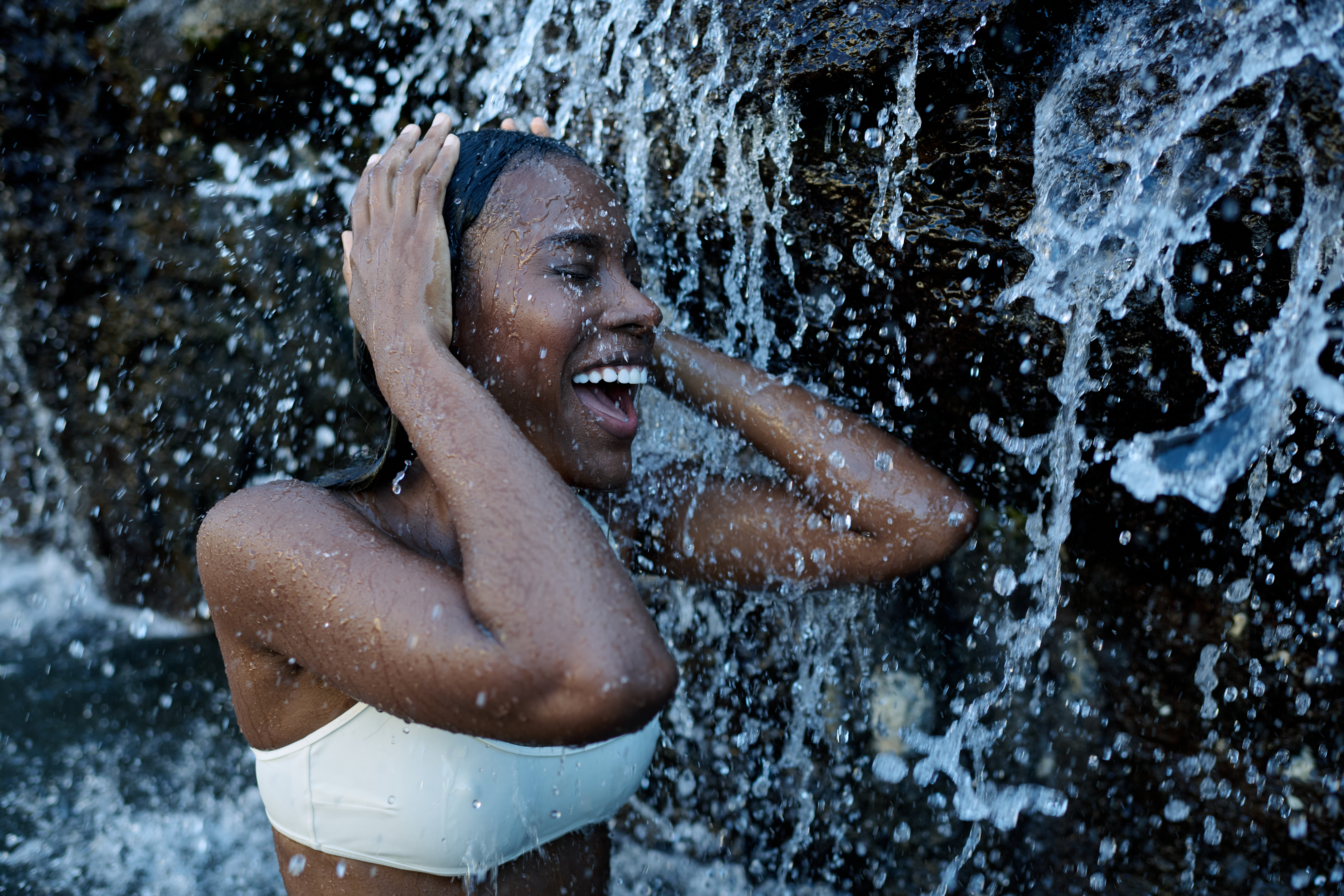 Model Enjoying a Waterfall on her Wellness Journey