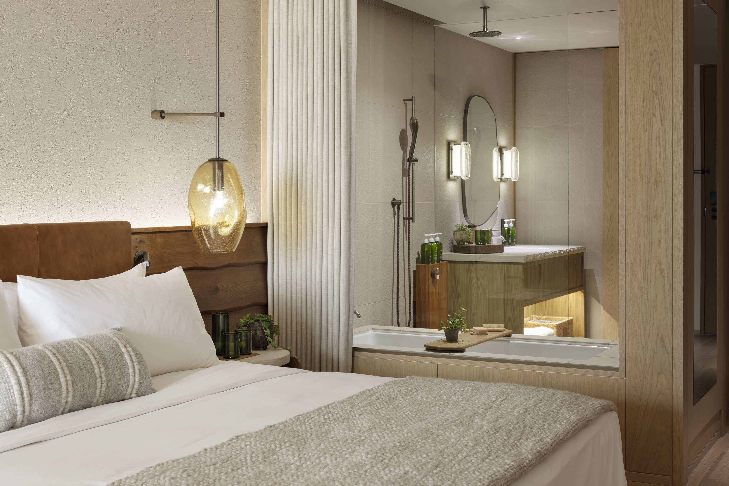 Modern bedroom and bathroom with glass