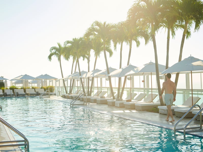Person walking along a pool deck