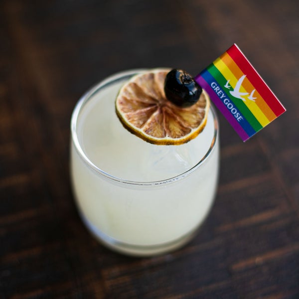 a cocktail with a rainbow flag