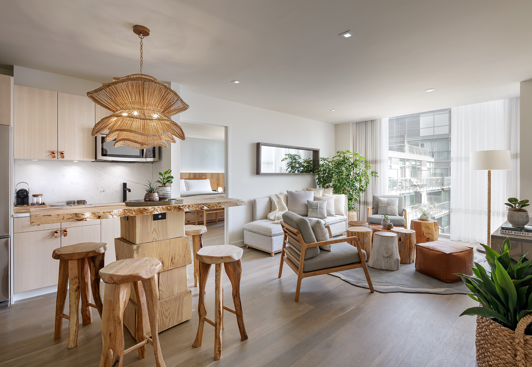 A 1 Hotels suite with full kitchenette, living room area, and bedroom